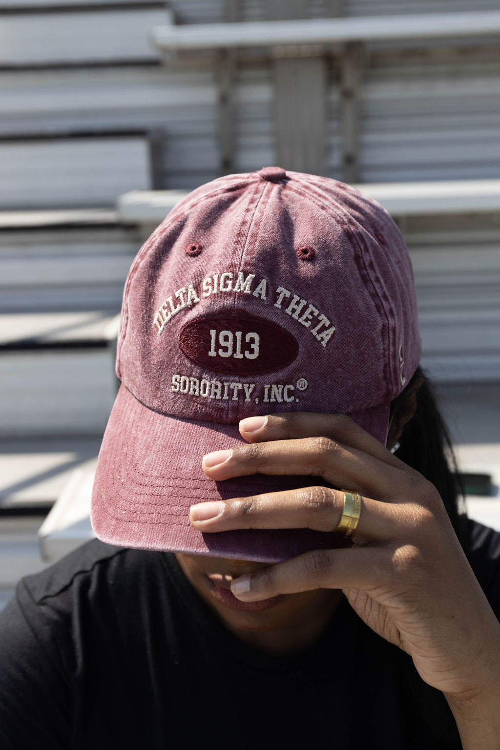 Person wearing a maroon Delta Sigma Theta cap with '1913 Sorority, Inc.' text.