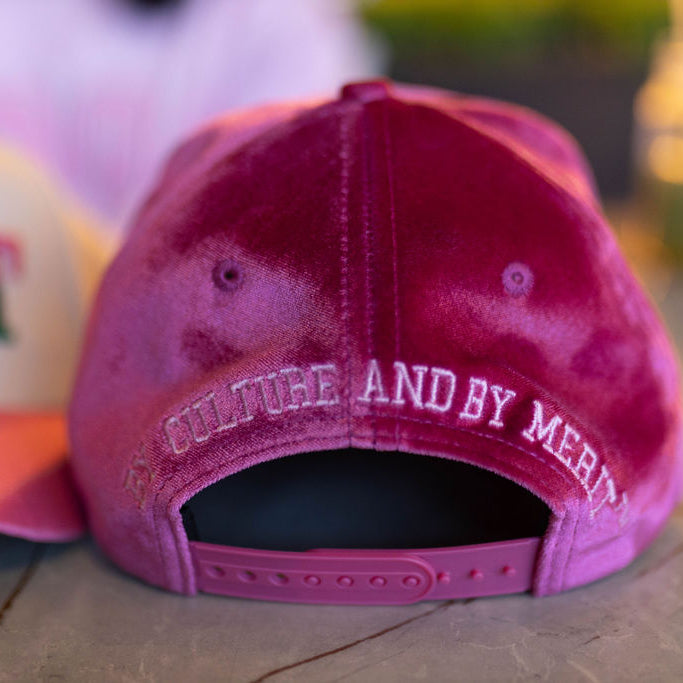 Pink cap with text on a blurred background