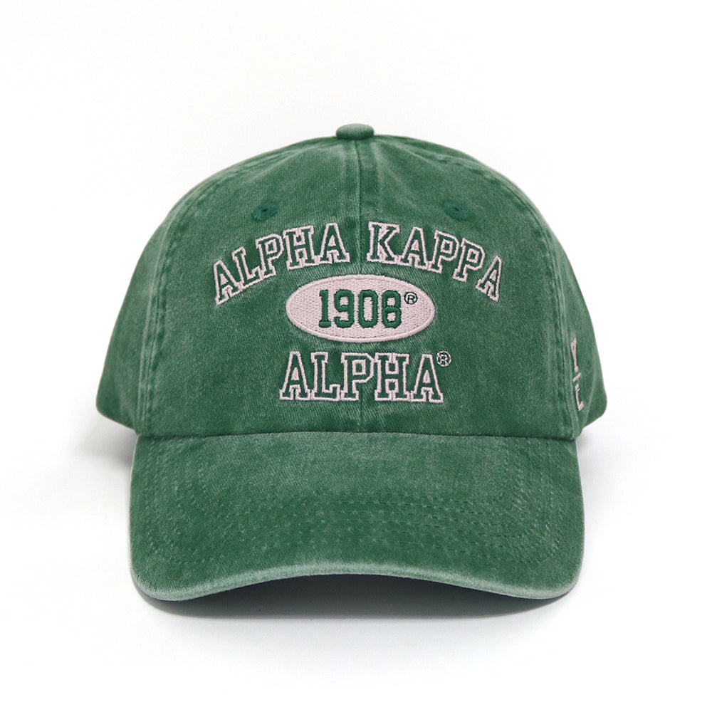 Green cap with Alpha Kappa Alpha logo on a white background