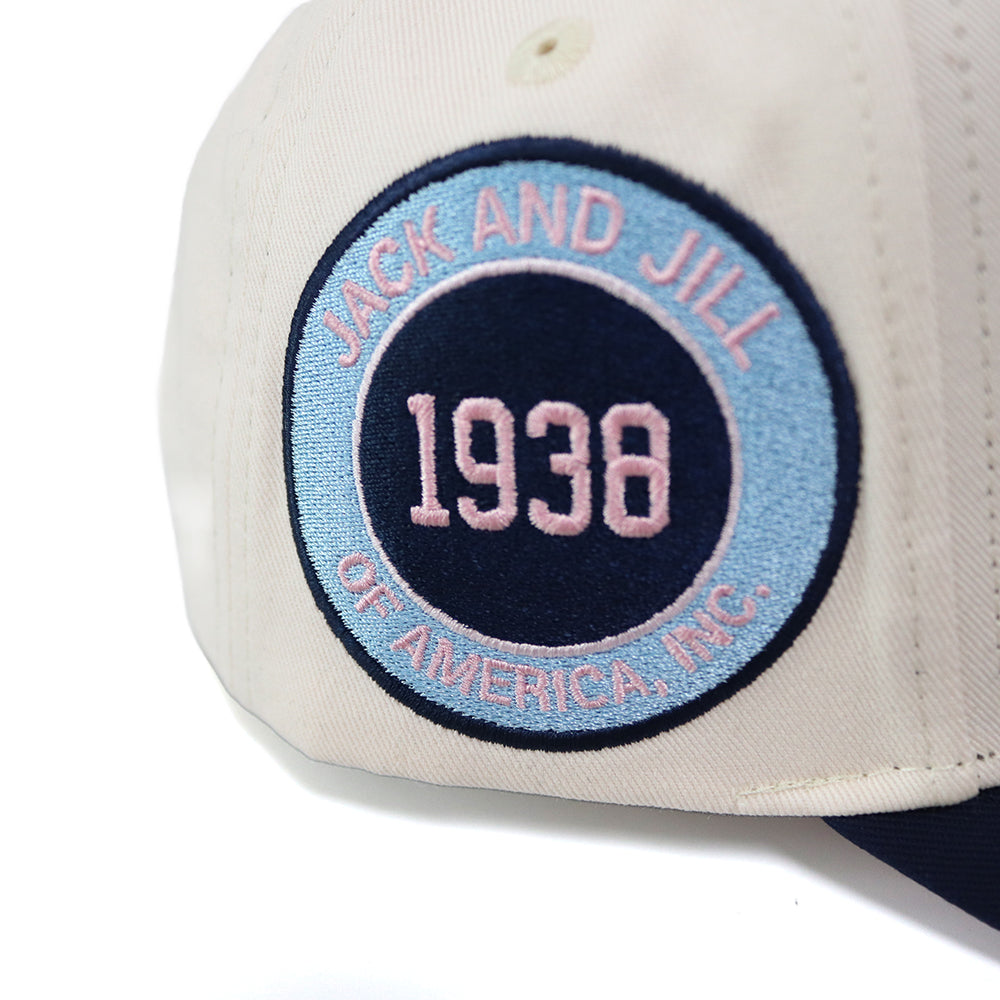 Close-up of a patch on cap with 'Jack and Jill of America, Inc.' logo and text.