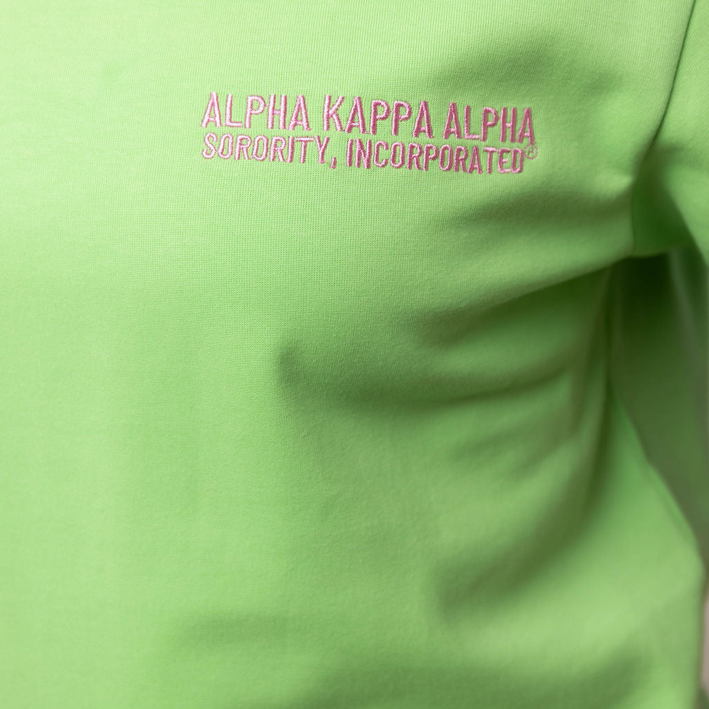 Green shirt with 'Alpha Kappa Alpha Sorority, Incorporated' text in pink on a plain background