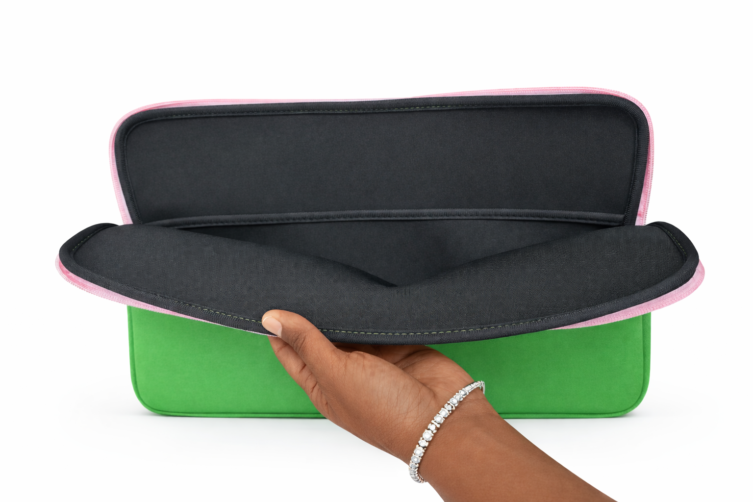 Green and pink case with a hand holding it open on a white background