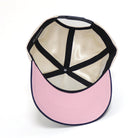 snapback hat showing satin lining and pink brim