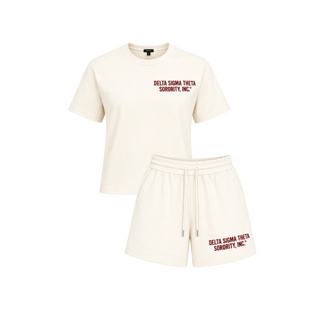 An off-white matching lounge set consisting of a short-sleeve crewneck t-shirt and drawstring shorts, both featuring the text 'DELTA SIGMA THETA SORORITY, INC.' printed in dark red on the chest and left leg.