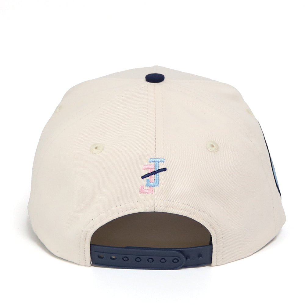 Beige cap with a logo on the back against a white background