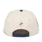 Beige cap with a logo on the back against a white background